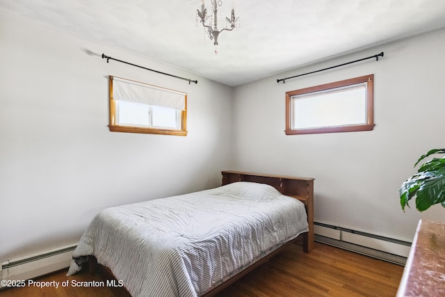 2807 S Webster Ave, Scranton, PA 18505 - bedroom with a baseboard radiator, a baseboard heating unit, multiple windows, and wood finished floors