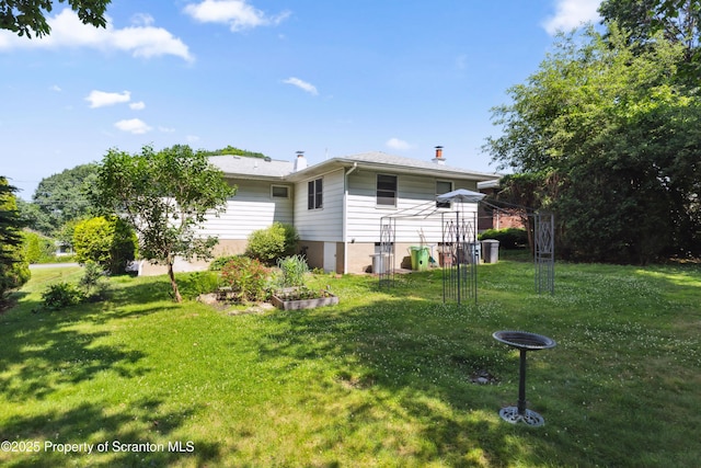 2807 S Webster Ave, Scranton, PA 18505 - back of property with a lawn and a chimney