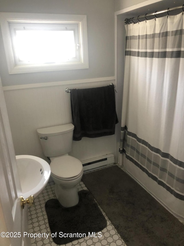505 Main Ave, Clarks Summit, PA 18411 - bathroom featuring a baseboard heating unit, toilet, curtained shower, and a sink