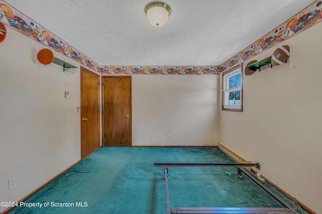 carpeted spare room featuring a textured ceiling