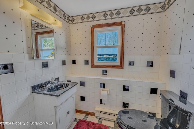 bathroom featuring tile patterned flooring, vanity, toilet, and tile walls