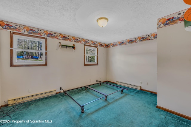 playroom with a textured ceiling, carpet floors, and baseboard heating