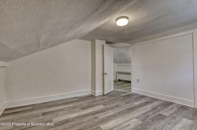 326 Neptune Pl, Scranton, PA 18505 - bonus room with radiator, a textured ceiling, wood finished floors, and lofted ceiling