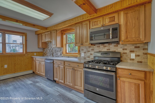 326 Neptune Pl, Scranton, PA 18505 - kitchen with stainless steel appliances, light countertops, light wood-style floors, beam ceiling, and a wainscoted wall