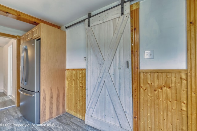 326 Neptune Pl, Scranton, PA 18505 - interior space with freestanding refrigerator, a barn door, wood finished floors, and wood walls
