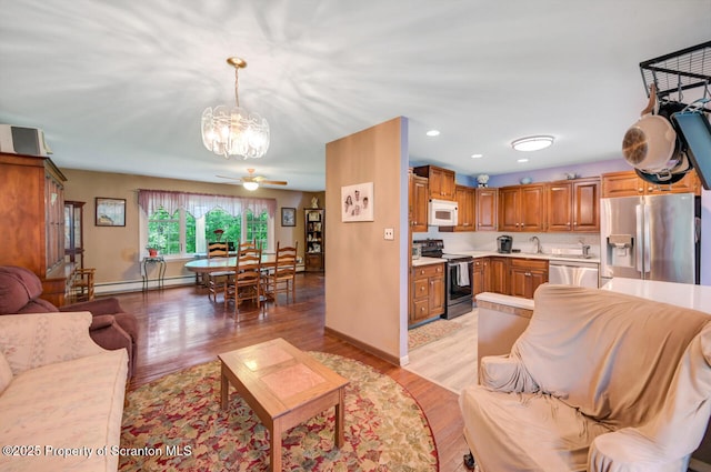 592 Gravel Pond Rd, Clarks Summit, PA 18411 - living area featuring a baseboard radiator, a chandelier, a ceiling fan, light wood finished floors, and recessed lighting