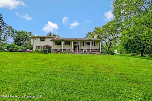 592 Gravel Pond Rd, Clarks Summit, PA 18411 - split foyer home featuring a chimney, a front yard, and covered porch