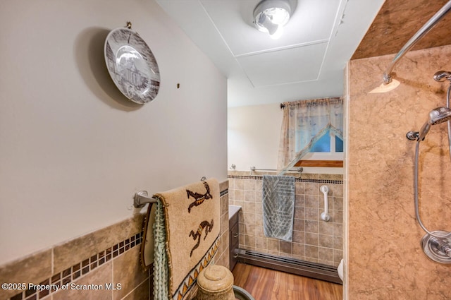 592 Gravel Pond Rd, Clarks Summit, PA 18411 - full bath featuring tile walls, a shower, a baseboard heating unit, a wainscoted wall, and wood finished floors