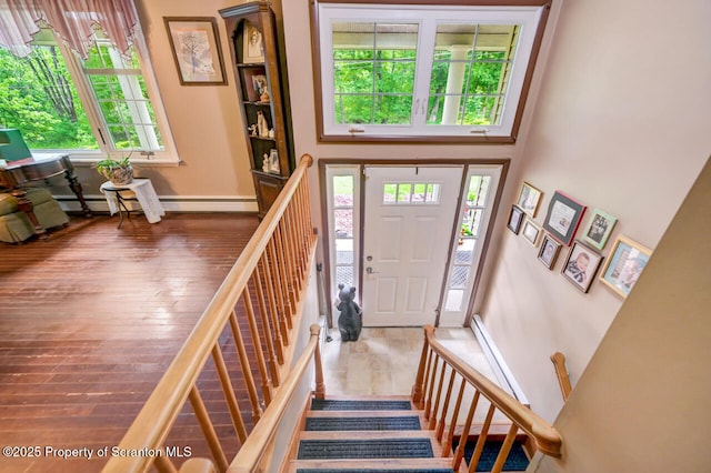 592 Gravel Pond Rd, Clarks Summit, PA 18411 - foyer entrance featuring baseboard heating, wood finished floors, stairs, and a towering ceiling