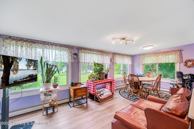 592 Gravel Pond Rd, Clarks Summit, PA 18411 - living area with wood finished floors, a water view, and a baseboard heating unit