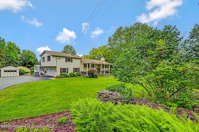 592 Gravel Pond Rd, Clarks Summit, PA 18411 - view of front of home with a chimney, a front yard, a garage, and asphalt driveway