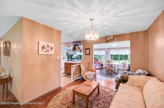 592 Gravel Pond Rd, Clarks Summit, PA 18411 - living room featuring light wood-style flooring, a chandelier, and baseboard heating