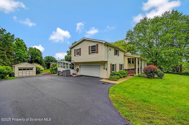 592 Gravel Pond Rd, Clarks Summit, PA 18411 - tri-level home featuring a front yard, an outdoor structure, and a garage