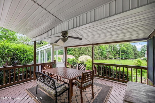 592 Gravel Pond Rd, Clarks Summit, PA 18411 - deck featuring outdoor dining area, ceiling fan, a sunroom, and view of scattered trees