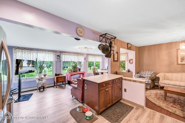 592 Gravel Pond Rd, Clarks Summit, PA 18411 - kitchen with open floor plan, light wood finished floors, light countertops, and a center island