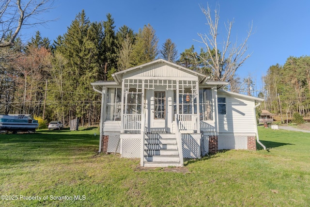 272 Lake Blvd, Clifford Twp, PA 18470 - bungalow-style home featuring a sunroom and a front lawn