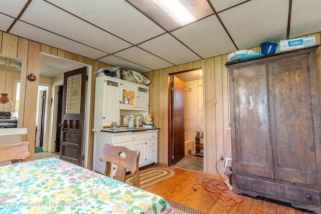 272 Lake Blvd, Clifford Twp, PA 18470 - bedroom with a paneled ceiling, wood walls, and light wood-style flooring