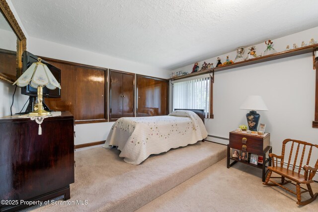 73 Quinton Rd, Scott Twp, PA 18447 - bedroom with light carpet, a textured ceiling, and a baseboard heating unit