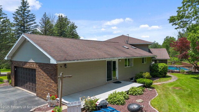 73 Quinton Rd, Scott Twp, PA 18447 - view of side of property featuring roof with shingles, brick siding, asphalt driveway, and an attached garage