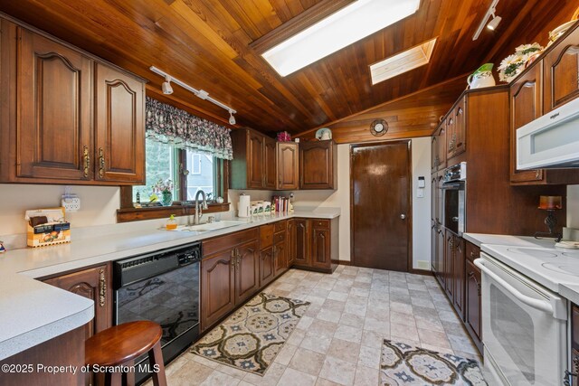 73 Quinton Rd, Scott Twp, PA 18447 - kitchen with white appliances, track lighting, wooden ceiling, vaulted ceiling, and light countertops