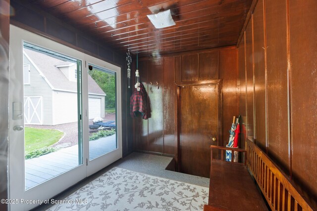 73 Quinton Rd, Scott Twp, PA 18447 - doorway to outside with wooden ceiling, carpet, and wooden walls