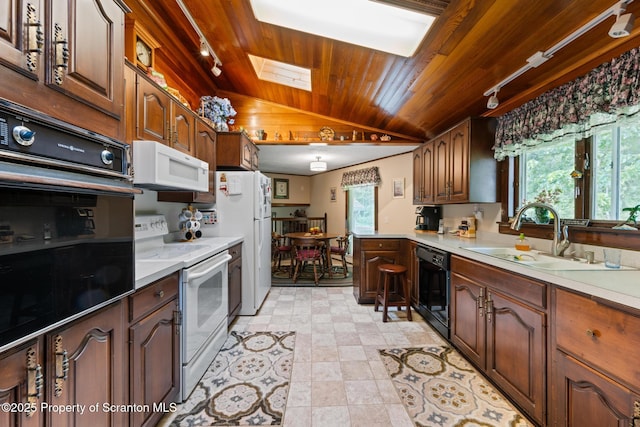 73 Quinton Rd, Scott Twp, PA 18447 - kitchen featuring black appliances, track lighting, wood ceiling, vaulted ceiling, and light countertops