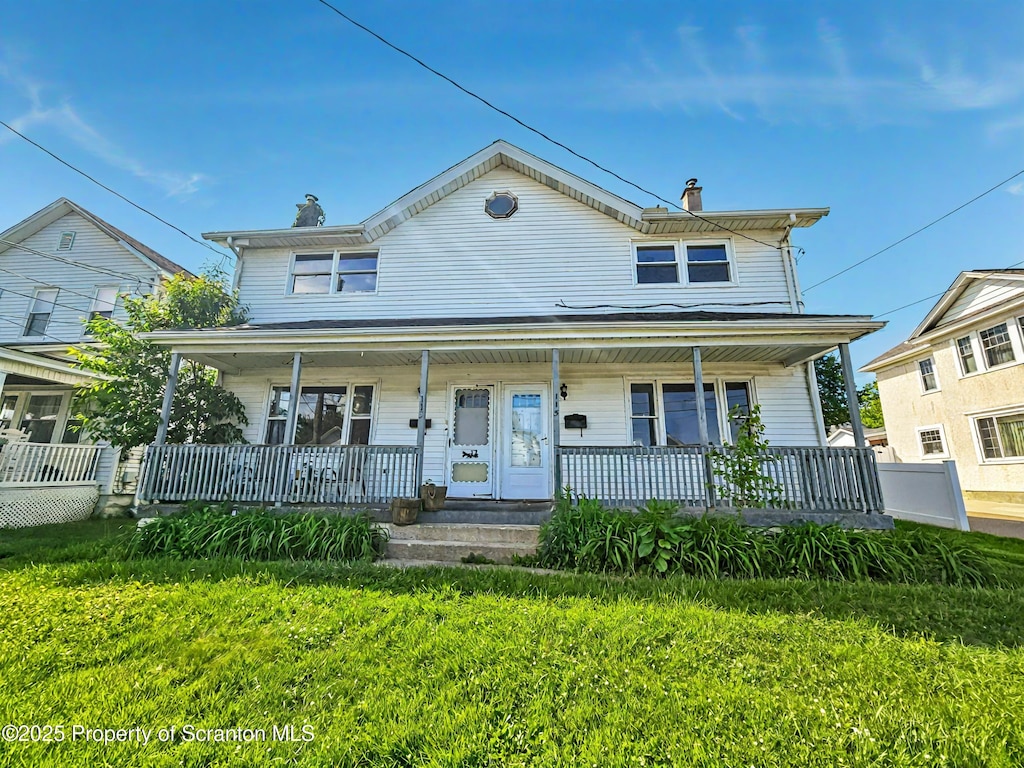 113-115 Third St, Blakely, PA 18447 - view of front facade featuring a porch, a front lawn, and a chimney