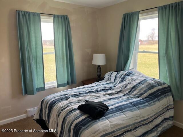 carpeted bedroom featuring baseboards