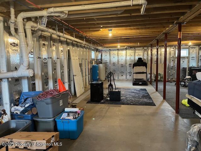 unfinished basement with gas water heater
