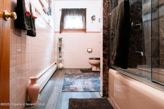 118 Howard St, Old Forge, PA 18518 - full bathroom with tile walls, tub / shower combination, wood finished floors, wainscoting, and baseboard heating