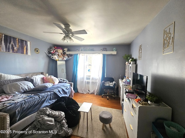 bedroom featuring ceiling fan and wood finished floors