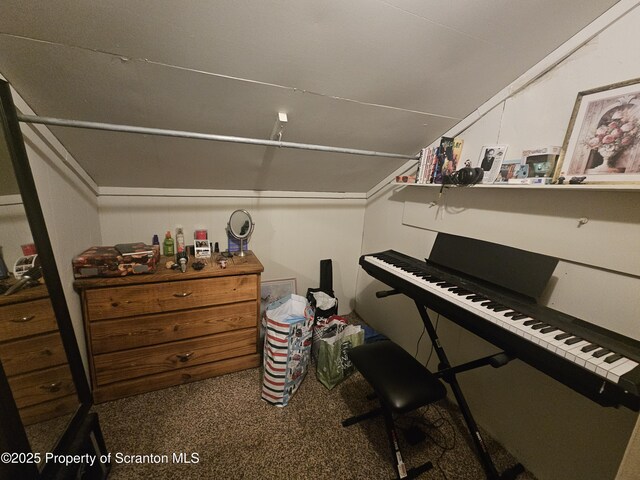 interior space with lofted ceiling and carpet floors