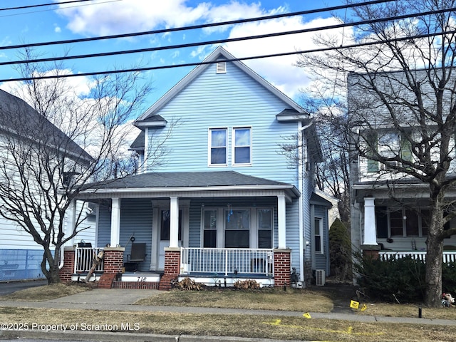 view of front of home with covered porch and roof with shingles