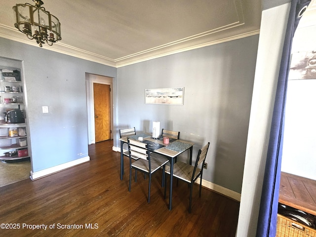 dining room with crown molding, baseboards, and wood finished floors