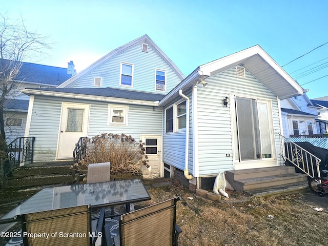 rear view of property with entry steps