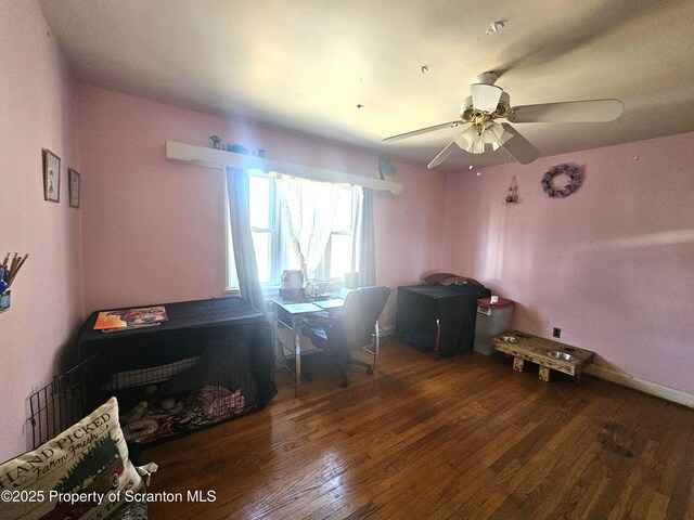 interior space featuring hardwood / wood-style floors, a ceiling fan, and baseboards