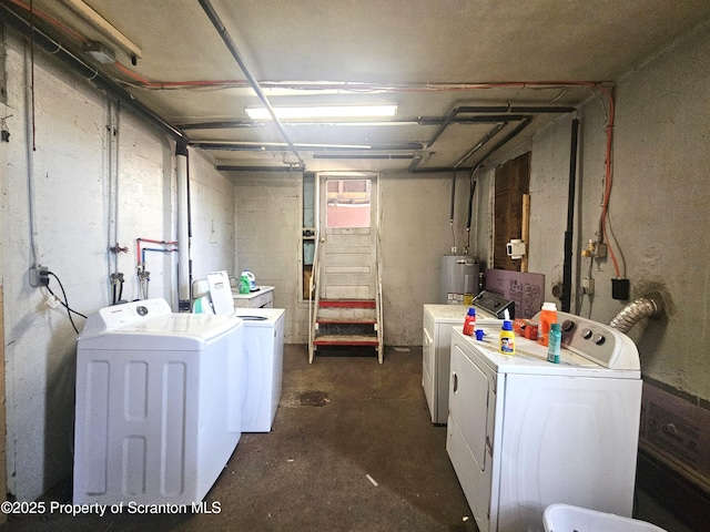 washroom featuring water heater, laundry area, and independent washer and dryer