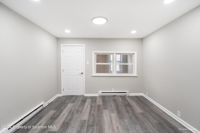 spare room featuring dark hardwood / wood-style floors and a baseboard radiator