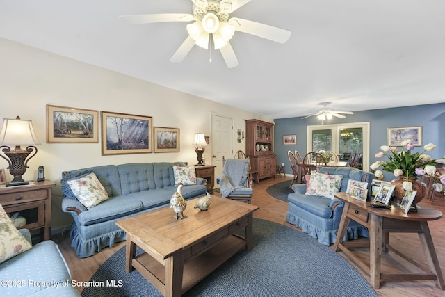 living room with a ceiling fan and wood finished floors