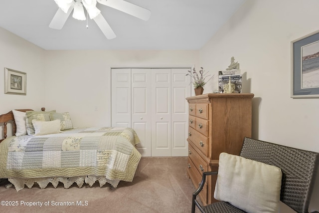 bedroom with ceiling fan, carpet, and a closet