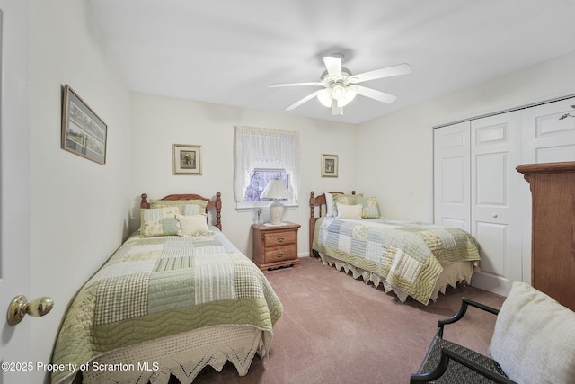 bedroom with ceiling fan, carpet, and a closet