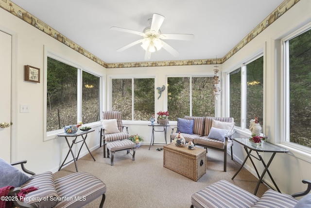 sunroom featuring a ceiling fan