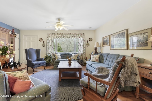 living area featuring ceiling fan and wood finished floors