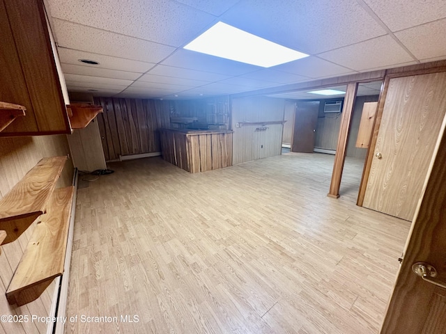 290 Holly Ln, Sturges, PA 18447 - finished basement featuring bar, a paneled ceiling, light wood finished floors, a baseboard heating unit, and a baseboard radiator