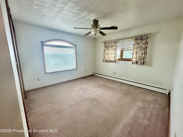 290 Holly Ln, Sturges, PA 18447 - carpeted spare room featuring a baseboard heating unit, ceiling fan, and a textured ceiling