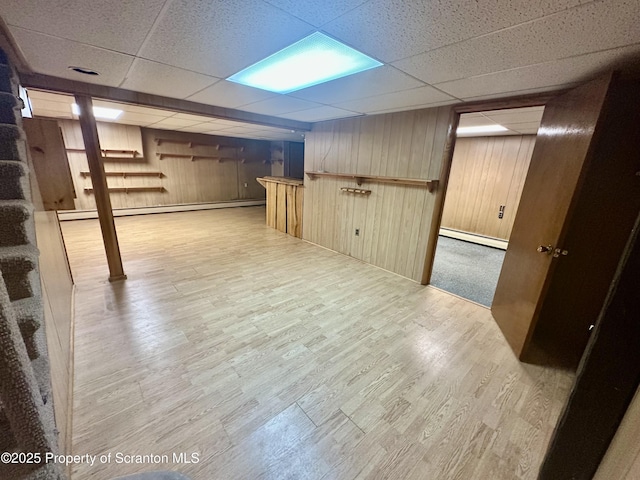 290 Holly Ln, Sturges, PA 18447 - finished basement with baseboard heating, a drop ceiling, wood finished floors, and wood walls