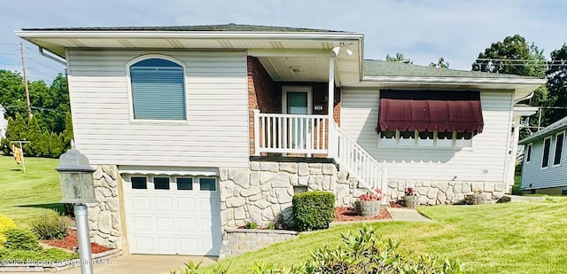 290 Holly Ln, Sturges, PA 18447 - view of front of house with a front lawn, an attached garage, driveway, and stone siding