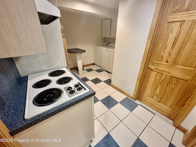 290 Holly Ln, Sturges, PA 18447 - kitchen with ventilation hood, white electric stovetop, dark countertops, white cabinets, and washing machine and dryer