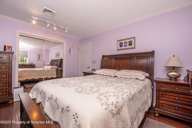 210 Willow Dr, Jefferson Twp, PA 18436 - bedroom with dark wood-style floors, a closet, crown molding, and rail lighting