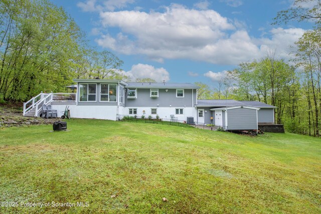 210 Willow Dr, Jefferson Twp, PA 18436 - rear view of property featuring a sunroom, a yard, and central AC